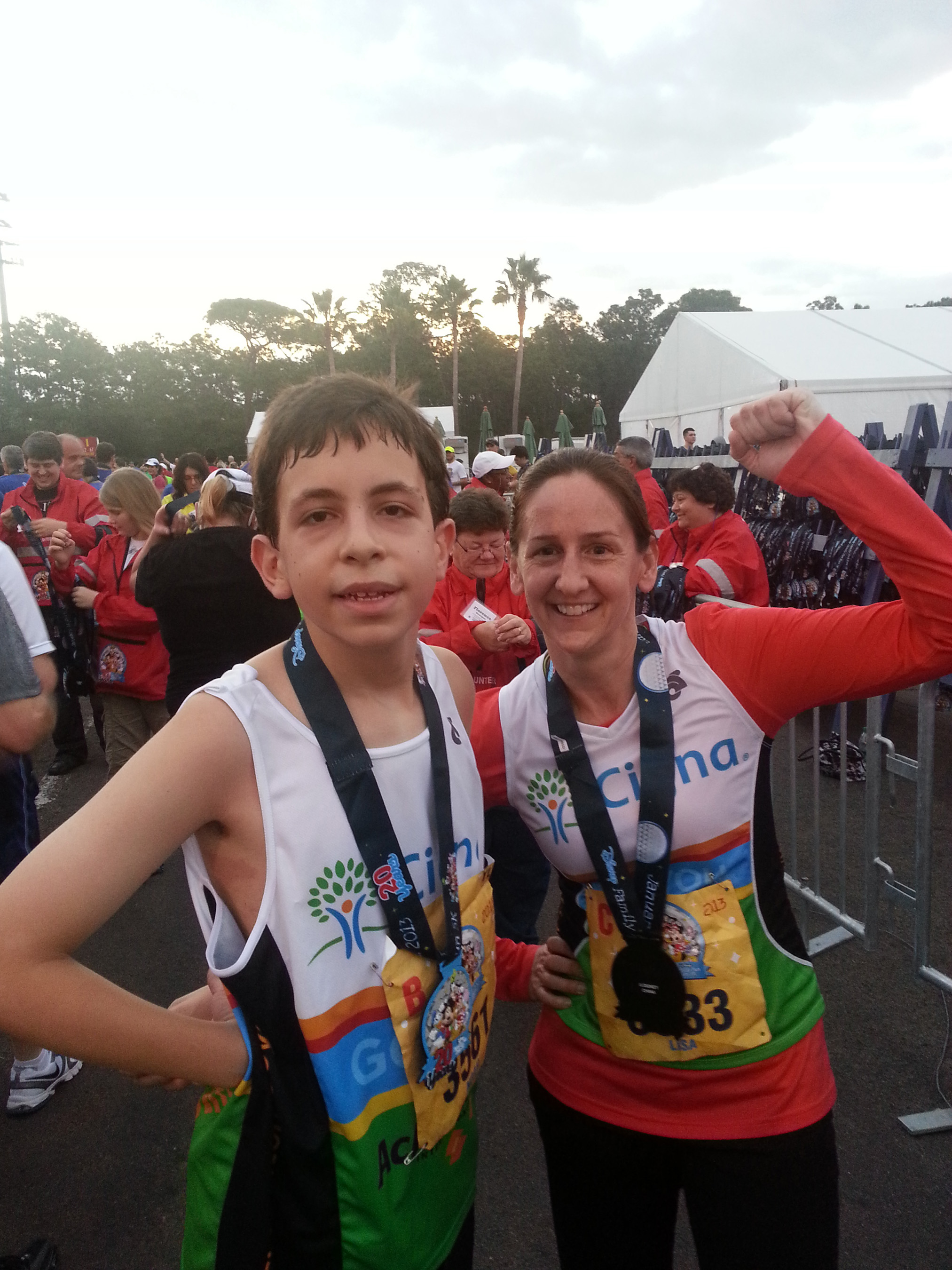Noah, an Achilles Kids athlete sponsored by Cigna, at finish line with his running partner, Lisa.