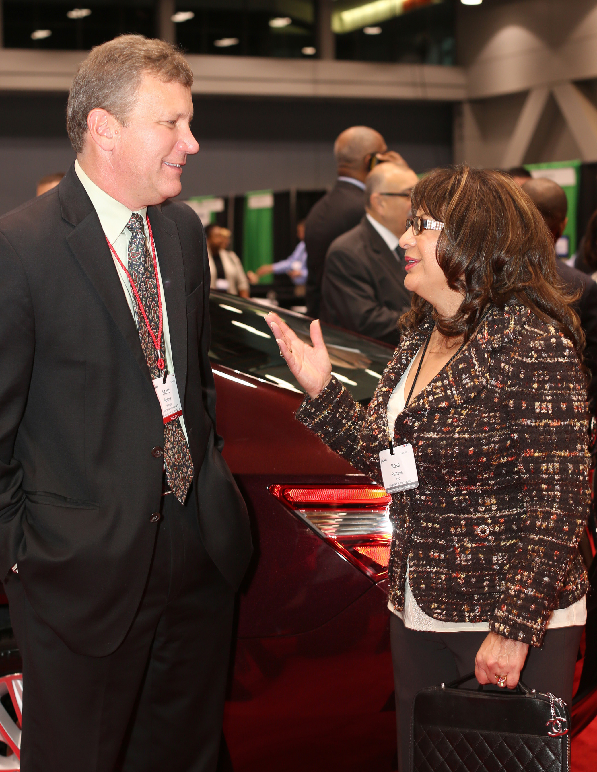 Rosa Santana, right, speaks with Matt Bonne, purchasing manager for TEMA, at the Toyota Opportunity Exchange. Santana’s Forma Automotive recently became the first Hispanic woman-owned direct supplier for Toyota.