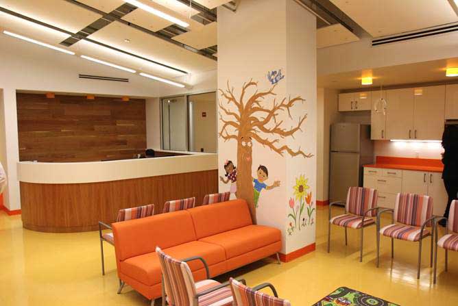 The Bronx CAC waiting room was designed to be inviting to children. Staff painted a mural of a tree and are asking visitors to write a message of hope on paper leaves.