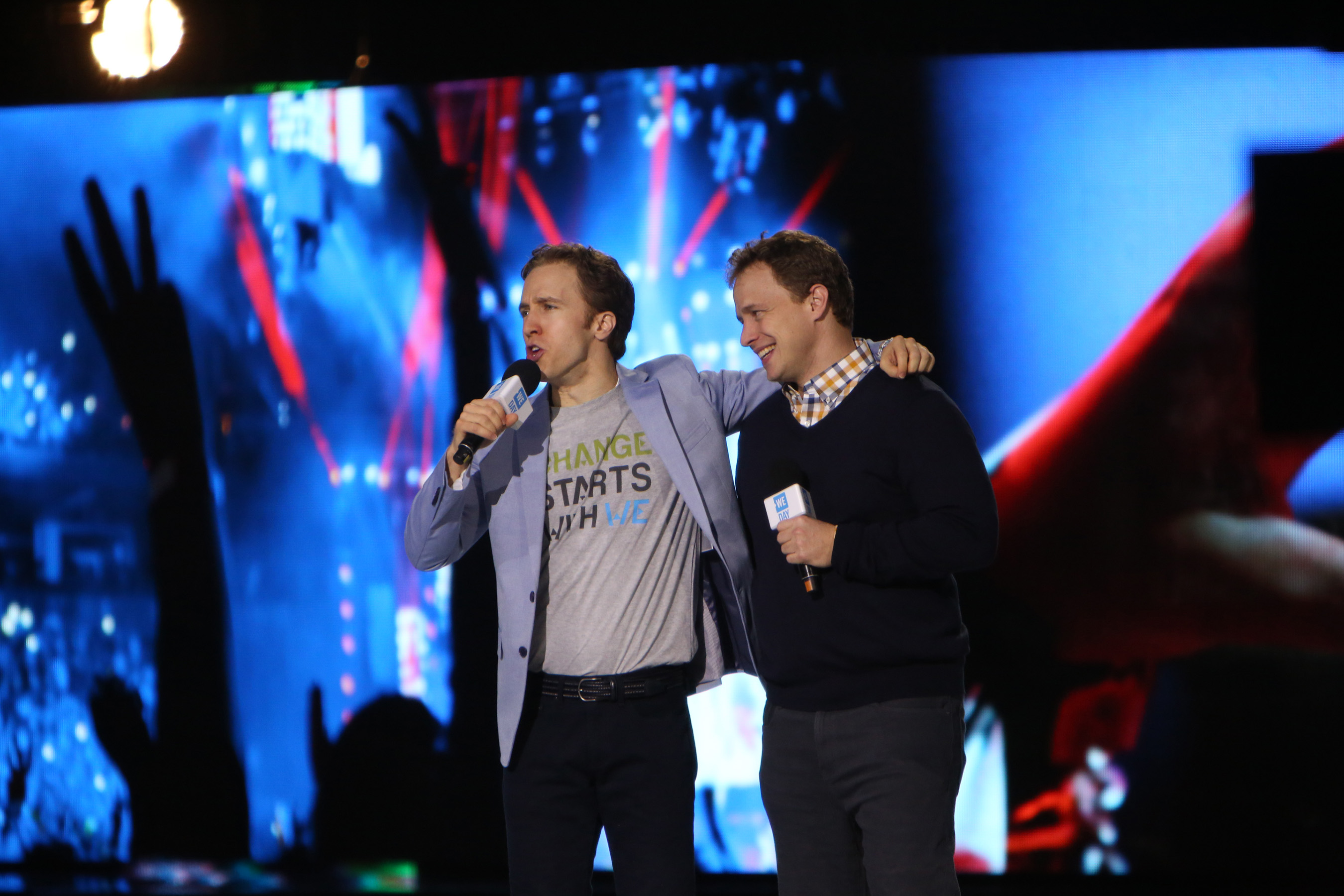  International activists and We Day co-founders, Craig & Marc Kielburger, inspire We Day crowd of young Americans to take action on local and global causes they care about. Photo Credit: Getty Images, Jeff Schear
