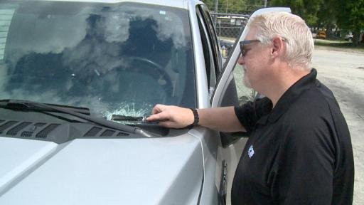 Guy pointing at cracked windshield