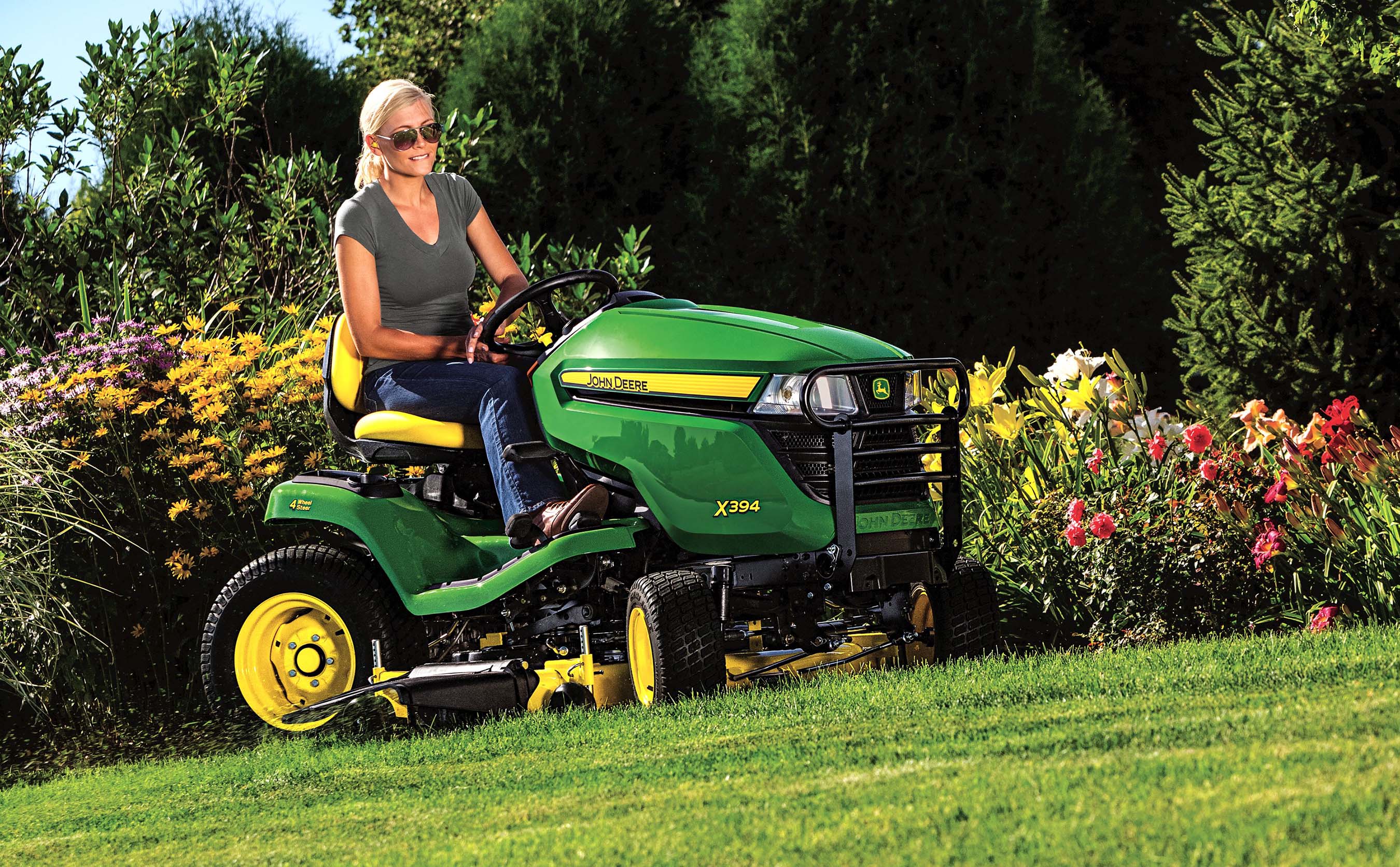The John Deere X394 Select Series tractor mower has four-wheel steering for superior maneuverability.