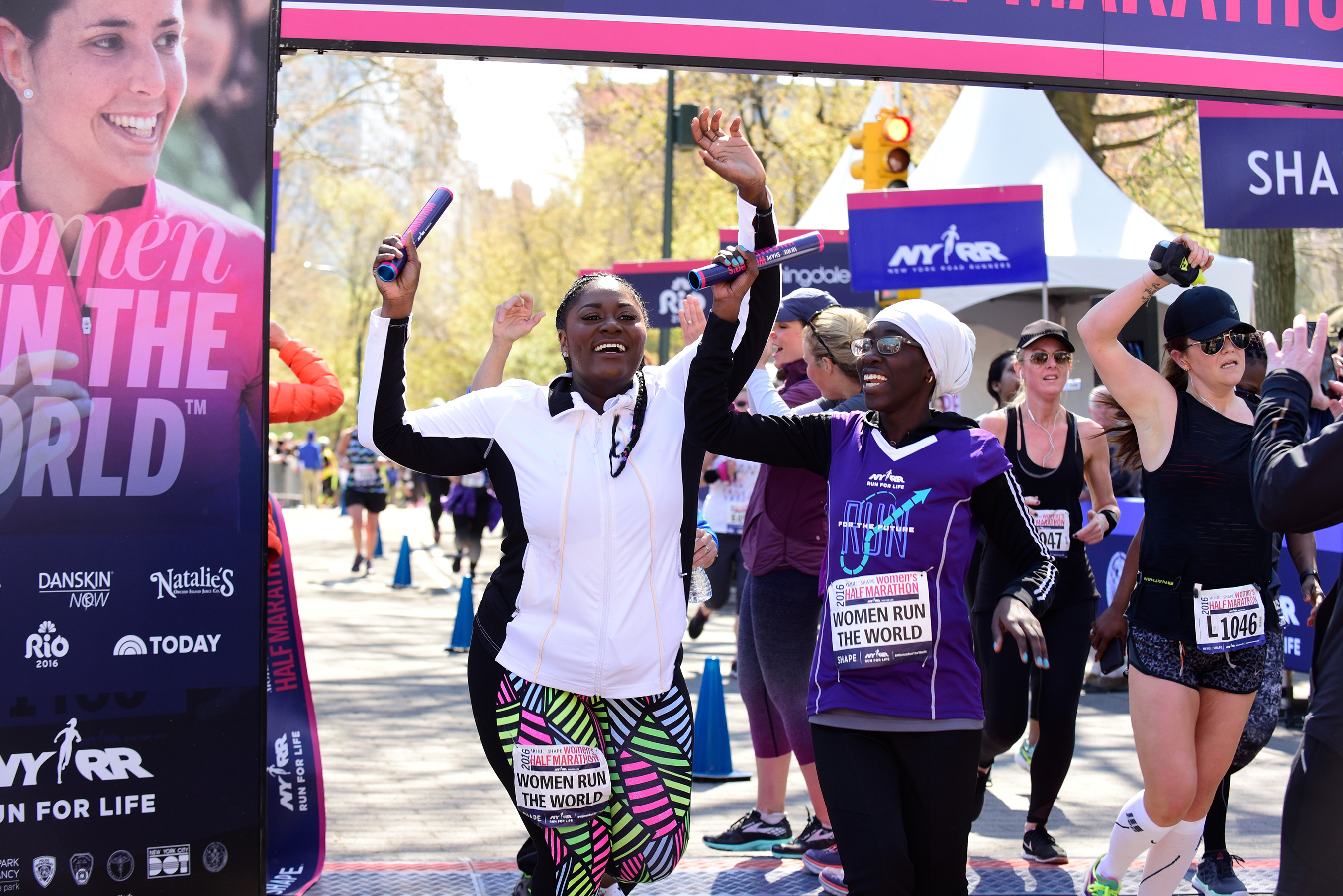 Actress Danielle Brooks and mentee Maty Sambe celebrate completing the final leg of the Women Run The World Relay at the MORE/SHAPE Women’s Half-Marathon in New York’s Central Park on April 17, 2016.