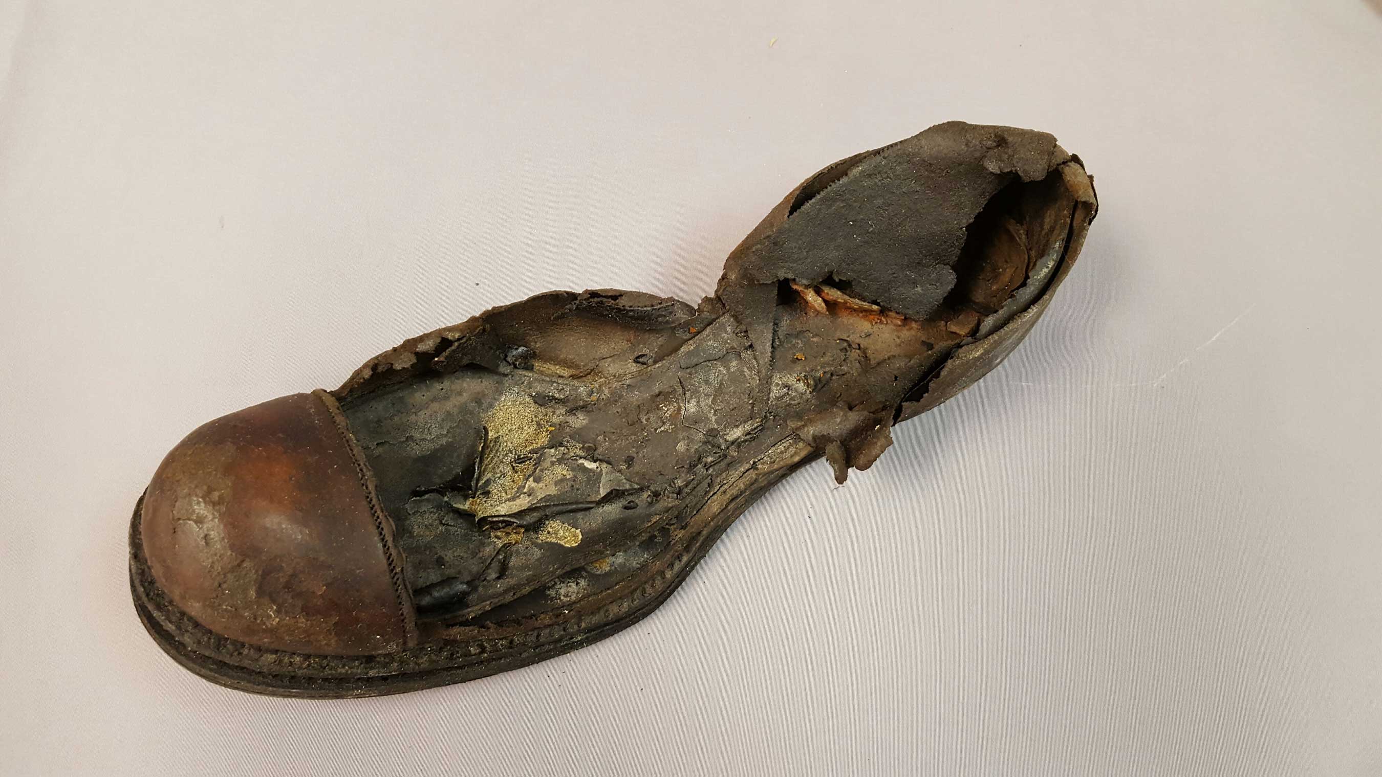 This men's leather shoe fragment consists of the welt, top cap and partial quarter with the insole. This shoe has never been previously exhibited due to its fragile condition. (Credit Premier Exhibitions)