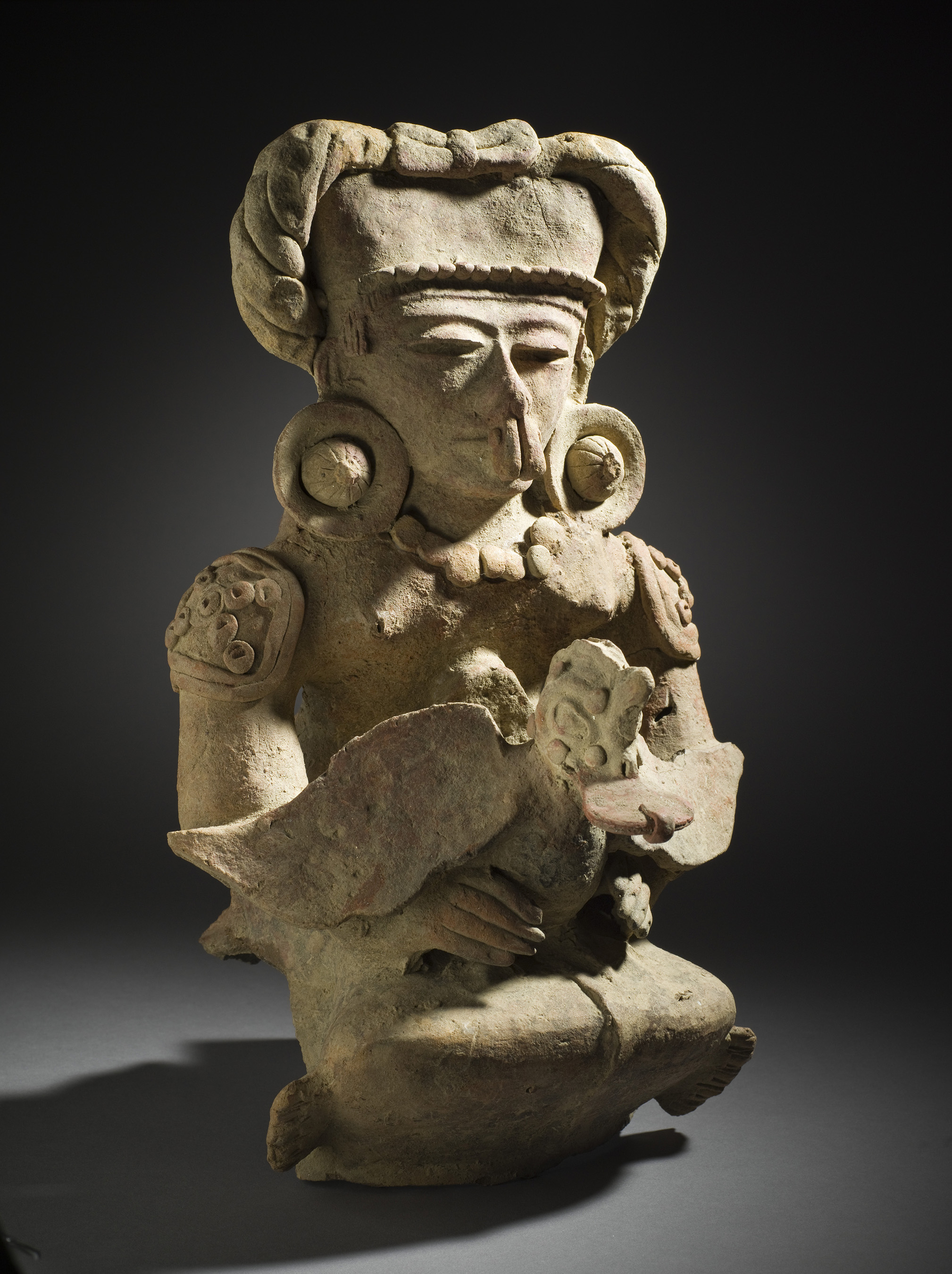 Unknown, Seated Figure Holding Duck, 400-600, Maya, Ceramic with specular hematite pigment, 13 3/4 x 8 3/4 x 9 in. (34.93 x 22.23 x 22.86 cm), Los Angeles County Museum of Art, Gift of the Art Museum Council in honor of the museum's twenty-fifth anniversary (M.90.168.45) Photo © Museum Associates/LACMA