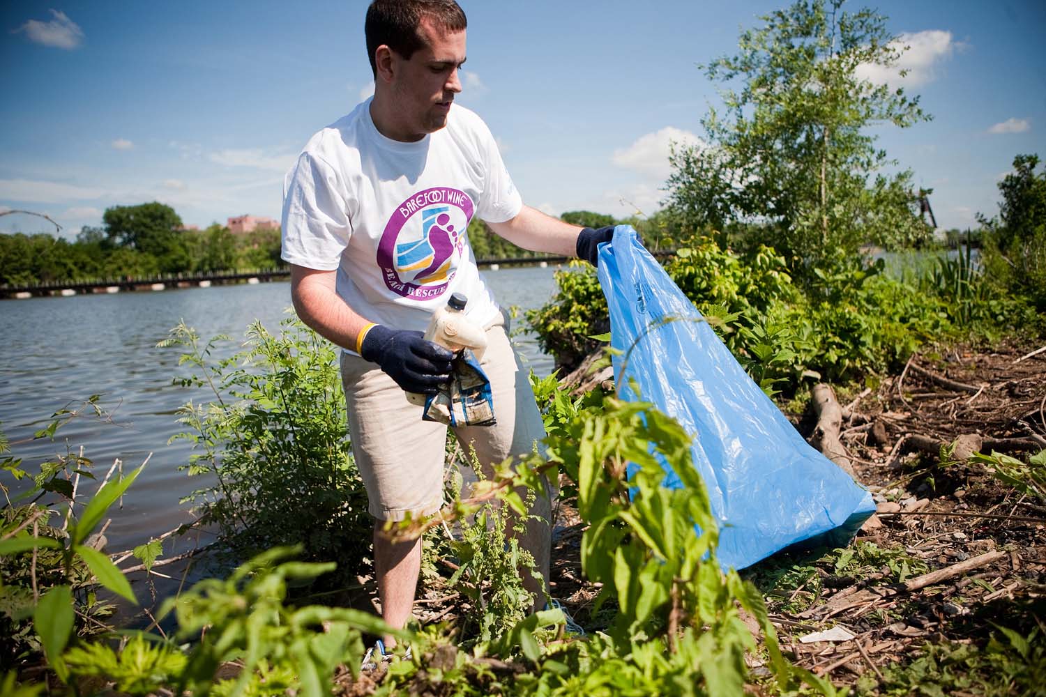 Barefoot Wine Beach Rescue Project Volunteer Pulls Trash from River Bank in Washington, D.C. in 2011