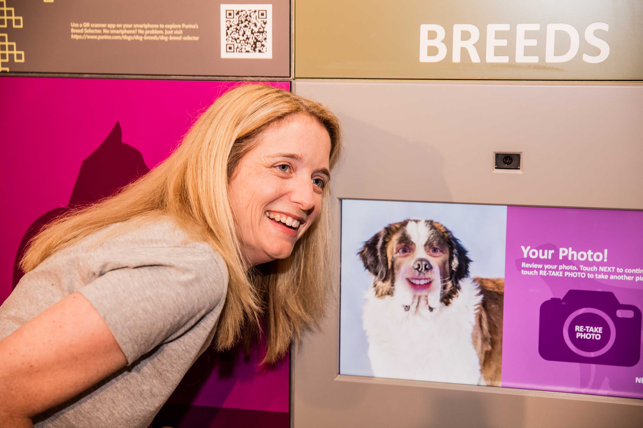 Tyne Benesek reveals a photo of herself morphed with a Saint Bernard during the July 14, 2016, grand opening of “Better with Pets,” a new exhibit at the Purina Visitor Center in Gray Summit, Missouri.