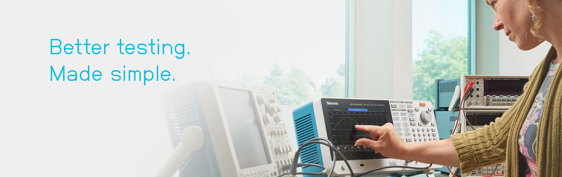 Woman using the AFG31000 with text overlayed: Better testing. Made simple.