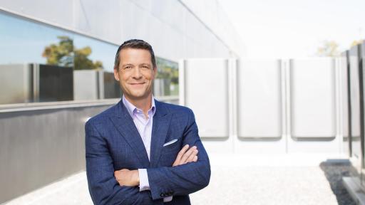 Portrait image of Charles Meyers in a bright room.