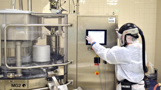 Man in a sterile suit working on a large machine