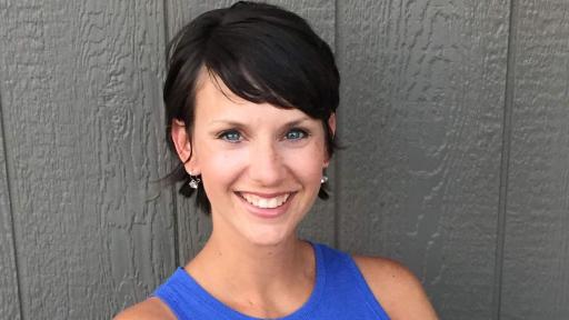 Portrait of Emily Dumler in a blue dress.