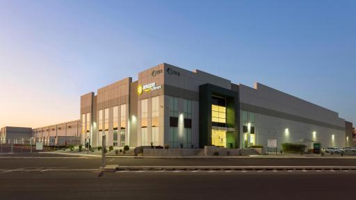 Man giving a presentation and pointing at a map while people in meeting watch.