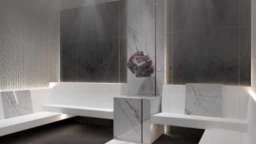 Grey and white room featuring a large chunk of crystal sitting between two seating areas.