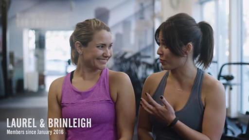 Two women in a gym talking
