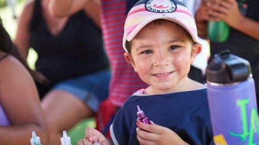 Little girl holding paint at Campout on the Field