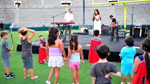 Children watch Us the Duo perform at Campout