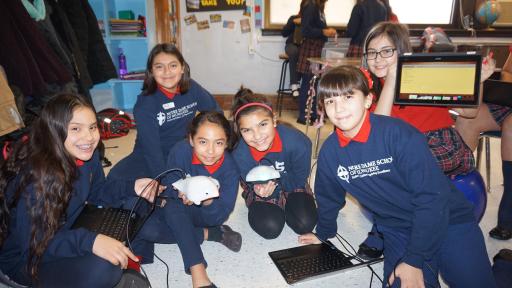 Students and teachers standing next to self-created maze