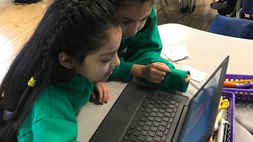 Two girls working on computer