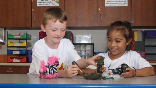 boy and girl assembling a bot