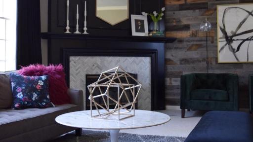 Living room after a home makeover, featuring a corner fireplace and mirror.