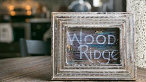Wooden picture frame with beautiful design around it and the words "Wood Ridge"
