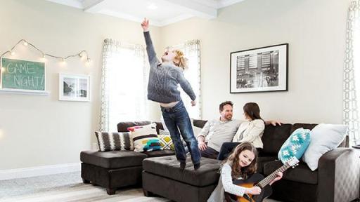 Parents sitting on couch, while kids play music.