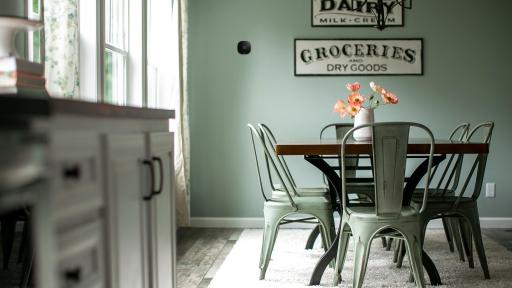 Dining room with sage green walls and sage green chairs, ecobee thermostat on wall