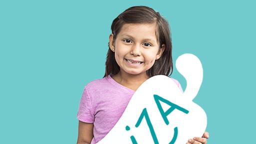 Child holding a cardboard pepper with her name on it - Briza