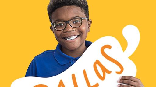 Child holding a cardboard pepper with his name on it - Dallas
