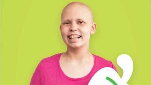 Child holding a cardboard pepper with her name on it - Kennan