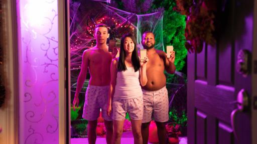 Two males, shirtless in Chili's boxers and one female wearing a white tank top and Chili's boxers at the entrance of a house for Halloween