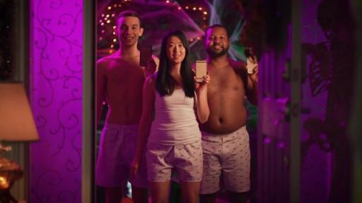 Three people standing in doorway with phones