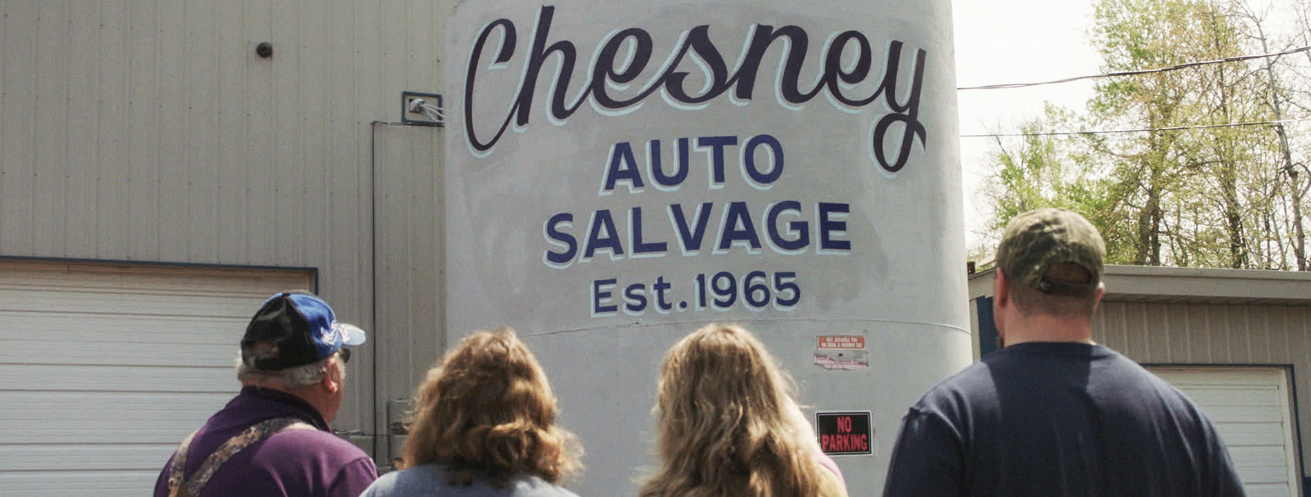 Hand-painted sign for Business that reads "Chesney Auto Salvage".