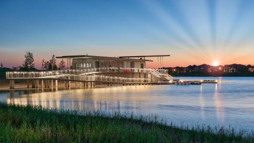 A modern boathouse at sunset.