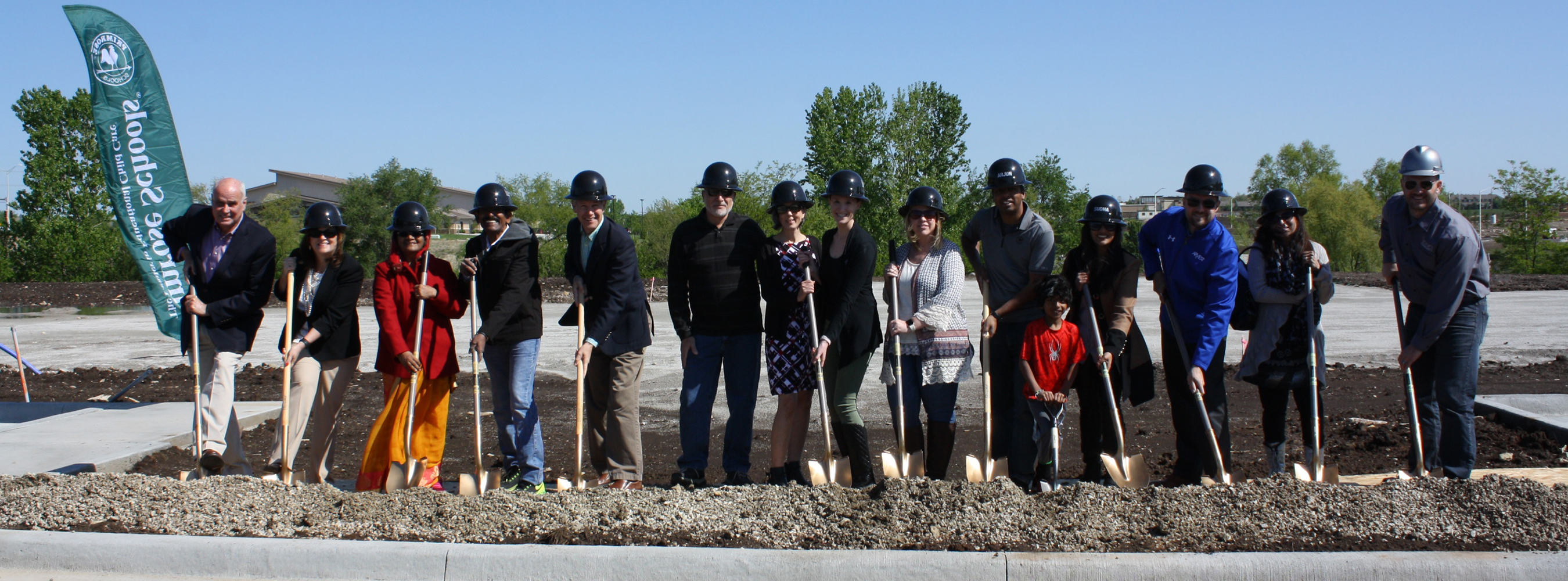 Banner image of group of people breaking ground on new construction site with shovels