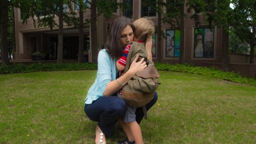 A woman hugging her young child