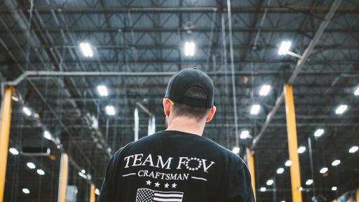 Brian Steorts standing in a factory with back to the screen, sporting a Team FOV Craftsman shirt.