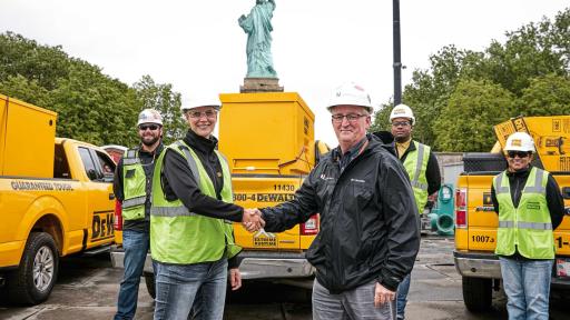 Woman and man shaking hands at the the Statue of Liberty Museum job site