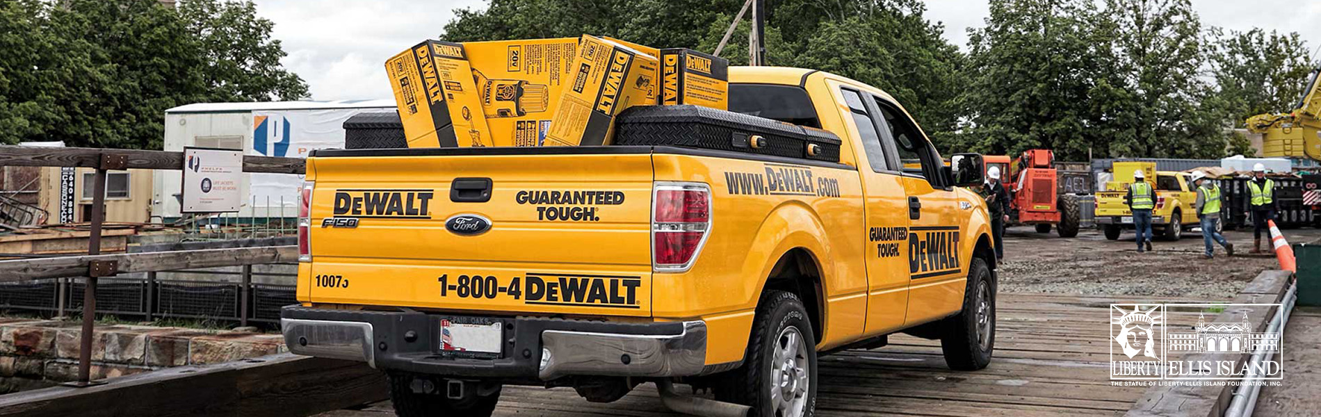 Yellow DeWalt construction truck with DeWalt products in the back.