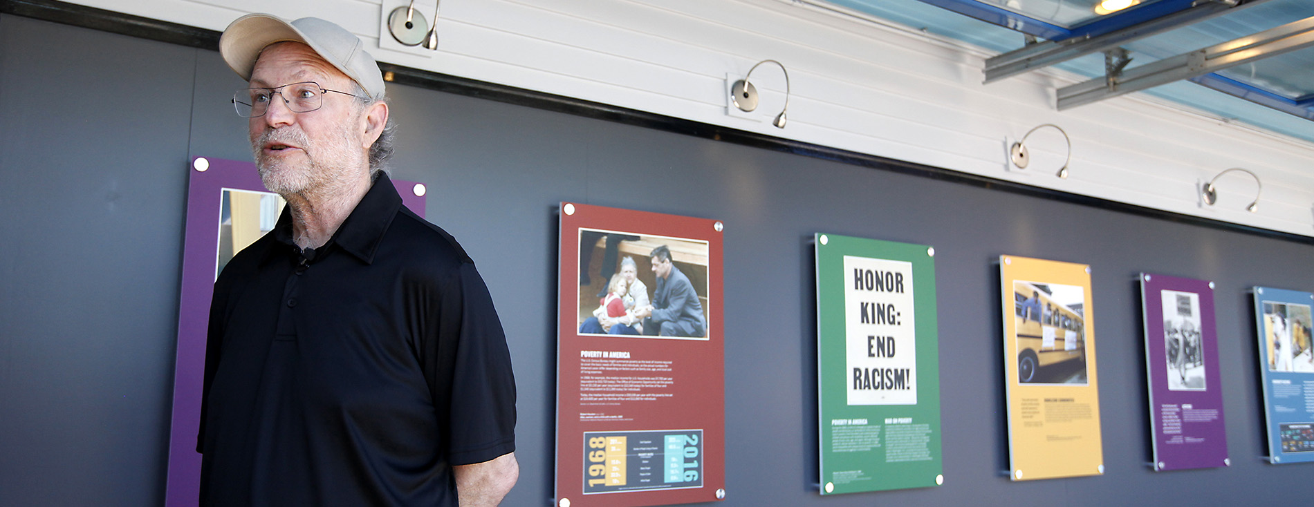 Man walking past a Smithsonian exhibit.