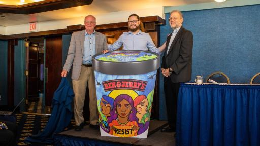 Ben & Jerry’s Co-founders Ben Cohen (left) and Jerry Greenfield (right) join Ben & Jerry’s CEO Matthew McCarthy (center) on stage unveiling a new flavor, Pecan Resist.