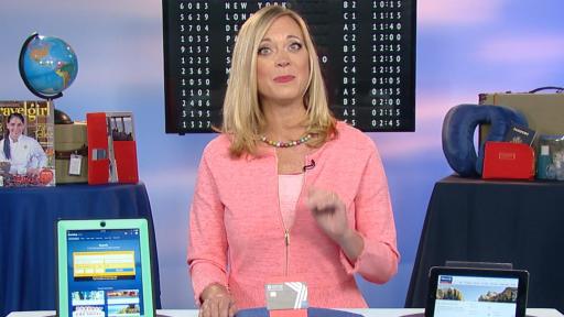 Blond woman announcer standing behind a table with a few tablets and a gift card on top of the table.