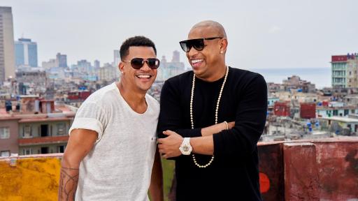 Gente de zona members, Alexander Delgado and
Randy Malcom, laughing  on a rooftop