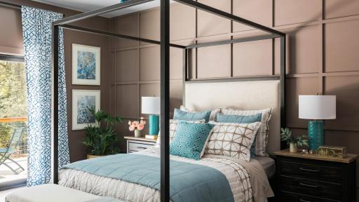 A master bedroom, complete with queen-sized bed, a nightstand on either side, and other fixtures. A patio is connected to the room.