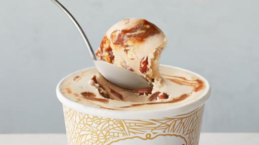 Spoon dipping in ice cream pint.