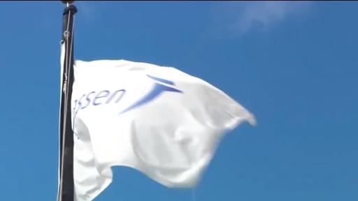 Janssen flag in the foreground with the blue sky in the background