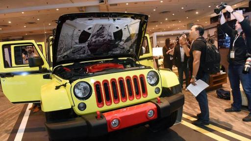 People viewing and taking pictures of the ROADM8 Jeep.
