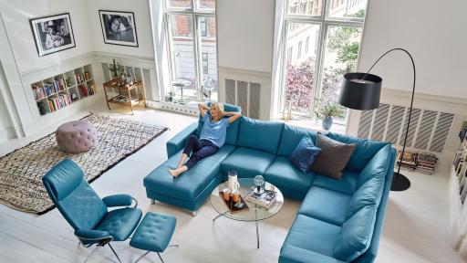 Woman lounging on blue leather sectional