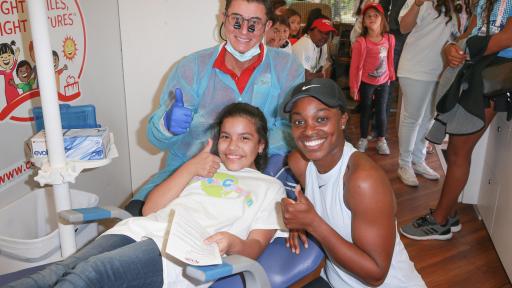 Kids and dentist give a thumbs-up.