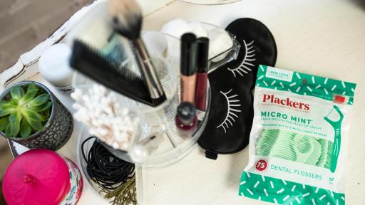 Plackers package in the middle of various toiletries.